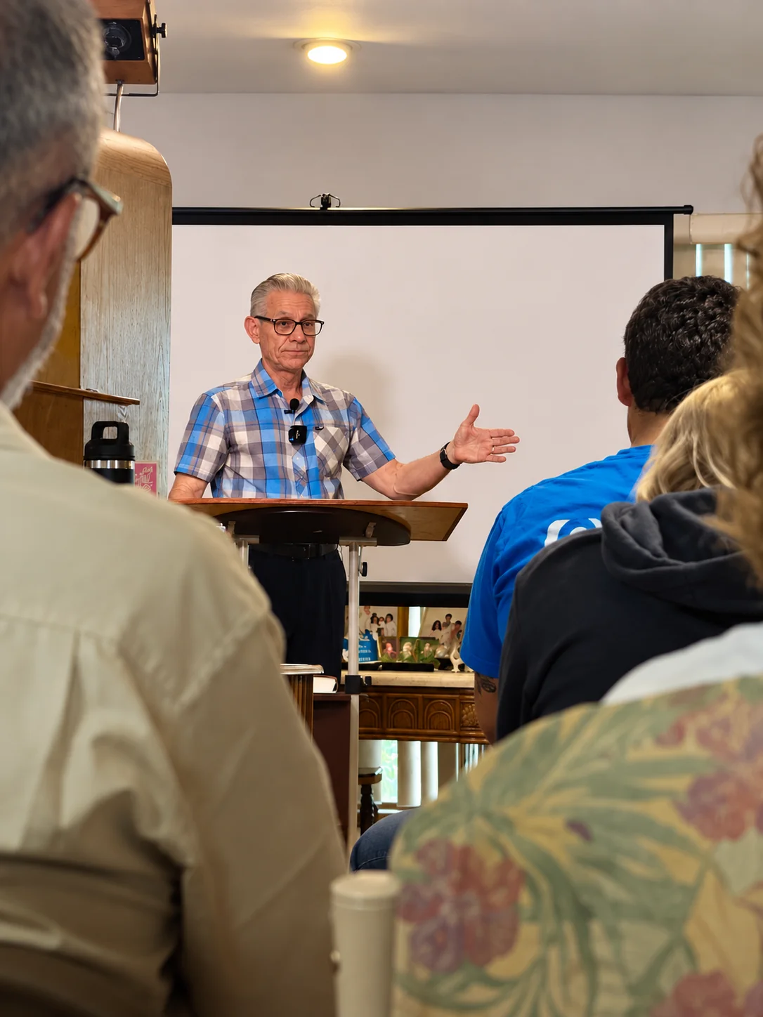 Pastor Frank preaching at the front of the Grace & Peace Church gathering